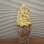 Chimney cake covered with Happy Sprinkles and Vanilla Ice Cream