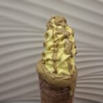 Chimney cake with Vanilla Ice Cream and covered with Pistacio cream