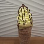 Chimney cake with Vanilla Ice Cream covered with Pistacio Cream and Belgian Chocolate