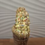 Chimney cake with Vanilla Ice Cream covered with Pistacio Cream and Happy Sprinkles